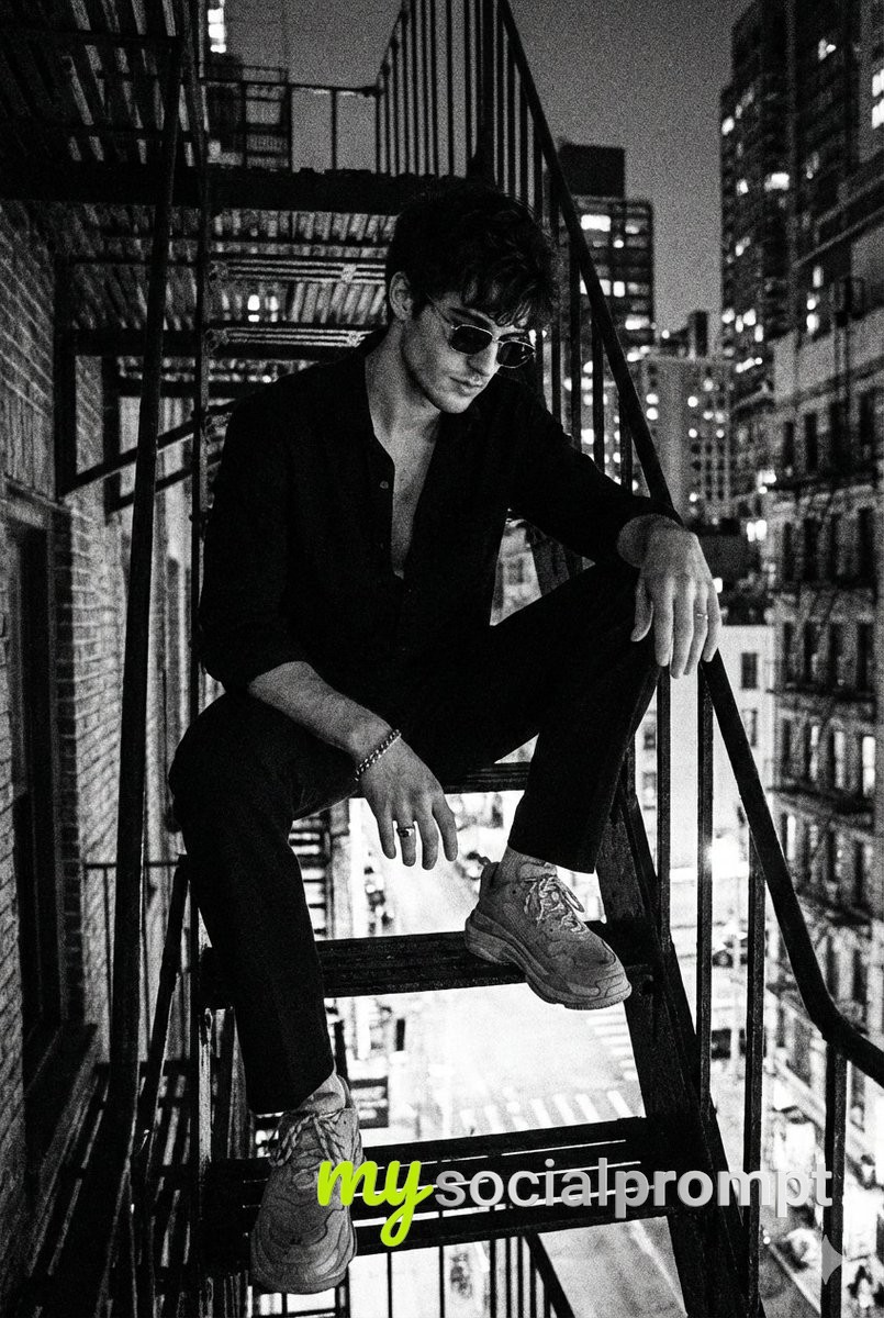 nanobanana prompt: Noir Portrait on Metal Staircase with Cityscape